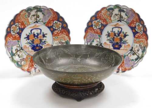A pair of Meiji period Japanese Imari dishes, of fluted form, decorated with reserves of cranes...