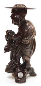 A late 19thC Chinese hardwood figure, modelled as a Buddhist monk, holding prayer beads and a... - 2