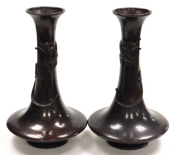 A pair of Japanese Meiji period bronze vases, of trumpet form, the neck entwined in relief with...