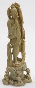 A 20thC Chinese soapstone figure of a fisherman, modelled standing on a rocky base, 40cm high,... - 2