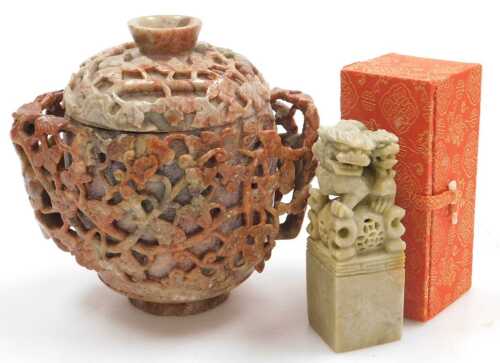 A 20thC Chinese soapstone pot and cover, of twin handled form, carved in relief with vines, 17cm...