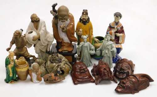 A group of 20thC Chinese Shiwan pottery mudman figures, including a seated lady, and deities,...