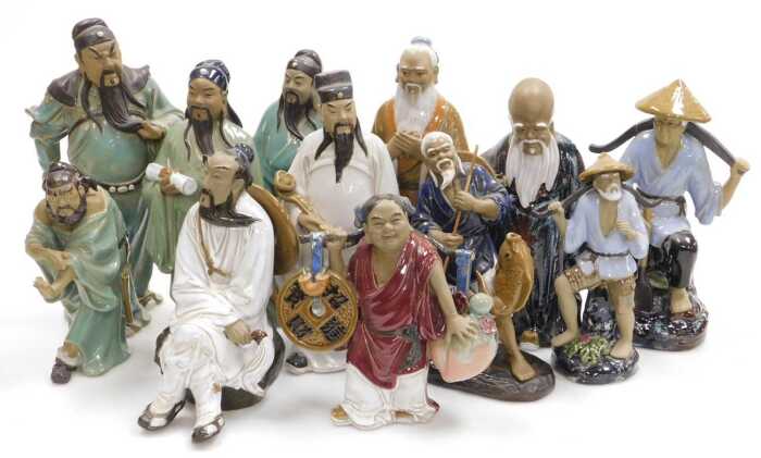 A group of 20thC Chinese Shiwan mudman figures, including deities, fishermen, and a woman...