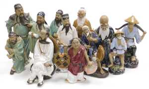 A group of 20thC Chinese Shiwan mudman figures, including deities, fishermen, and a woman...