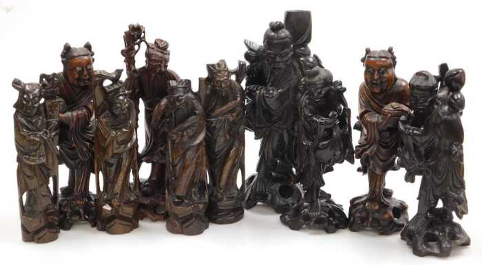 A group of late 19th and later Chinese hardwood figures, chiefly of emperors or deities, largest...