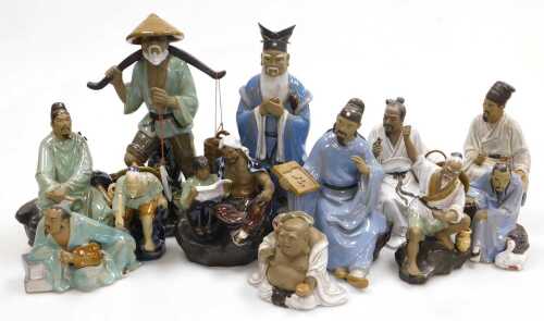 A group of 20thC Chinese Shiwan mudman figures, including a seated scholar, fisherman, a court...
