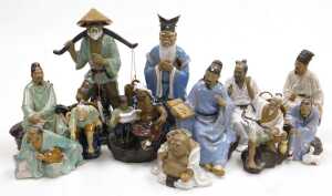 A group of 20thC Chinese Shiwan mudman figures, including a seated scholar, fisherman, a court...