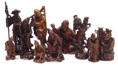 A group of 19thC and later Chinese hardwood carved figures, including deities, fishermen, a...