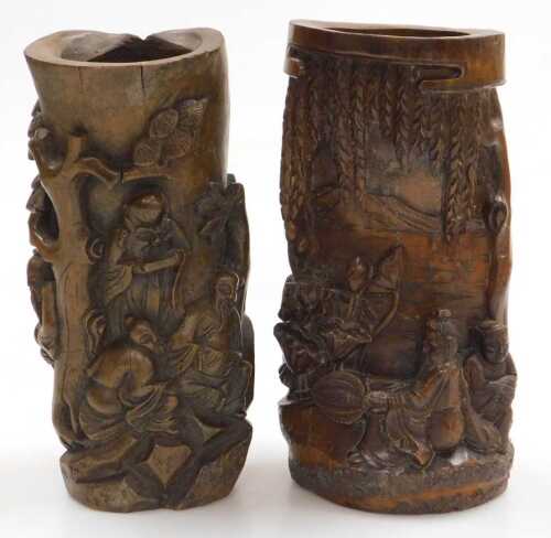 A 20thC Chinese carved bamboo brush pot, decorated in high relief with two figures seated upon...
