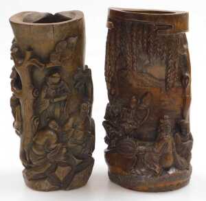 A 20thC Chinese carved bamboo brush pot, decorated in high relief with two figures seated upon...