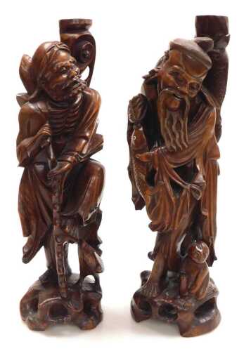 Two late 19thC Chinese hardwood figural carved table lamps, lacking fitments, both carved as...