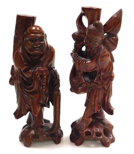 Two late 19thC Chinese hardwood figural carved table lamps, lacking fitments, both carved as...