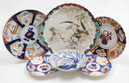 A Chinese Qing Dynasty blue and white porcelain dish, decorated with stylised birds on a tree,...