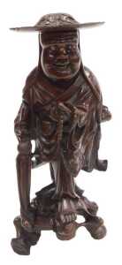 A late 19thC Chinese hardwood figure, modelled as a Buddhist monk, holding prayer beads and a...
