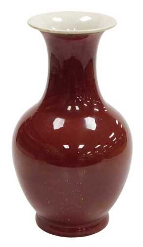 A 19thC Chinese sang-de-boeuf porcelain vase, of baluster form with an everted neck, 32cm high.