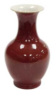 A 19thC Chinese sang-de-boeuf porcelain vase, of baluster form with an everted neck, 32cm high.