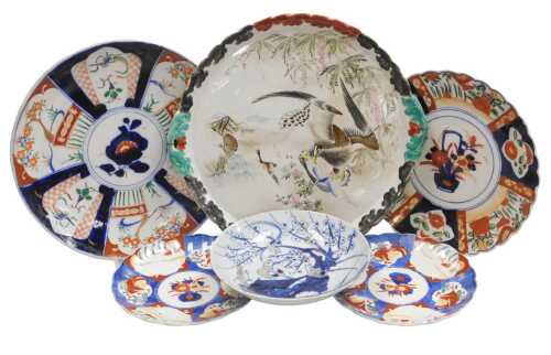 A Chinese Qing Dynasty blue, white and red porcelain dish, decorated with stylised birds on a...