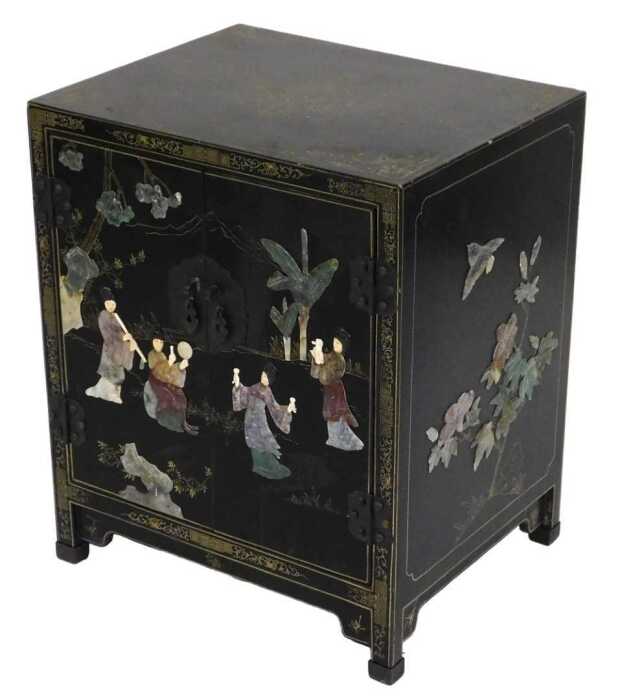 A Chinese black lacquered cupboard, of rectangular form, with floral and foliate scroll...