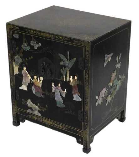 A Chinese black lacquered cupboard, of rectangular form, with floral and foliate scroll...