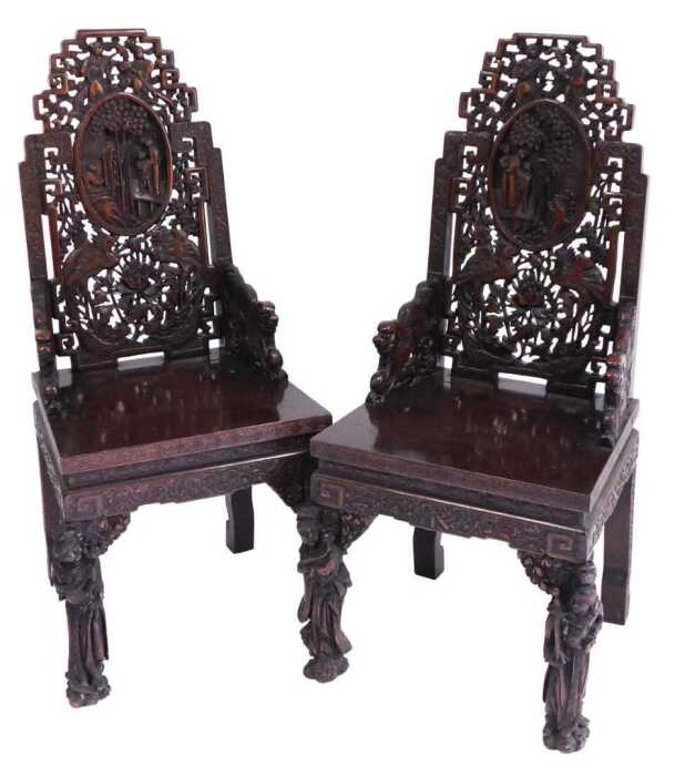A pair of early 20thC Chinese carved hardwood armchairs, with a fretwork back, having an oval...