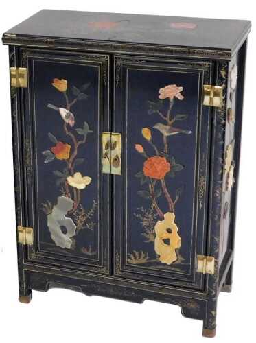 A Chinese black lacquer cabinet, of rectangular form, decorated with flowers, and overlaid in...