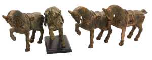 Four Chinese Tang style cast iron figures of war horses, one raised on a wooden plinth, with...