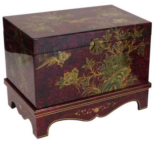 A Chinese scumbled red and black lacquer chest, decorated with birds and flowers, having a...
