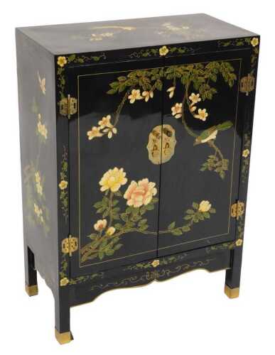 A Chinese black lacquer cabinet, of rectangular section, painted with birds, trees in blossom,...