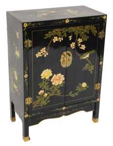 A Chinese black lacquer cabinet, of rectangular section, painted with birds, trees in blossom,...
