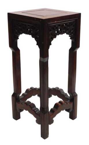 A small Chinese hardwood urn stand, of square section, with scrolling fretwork raised on square...