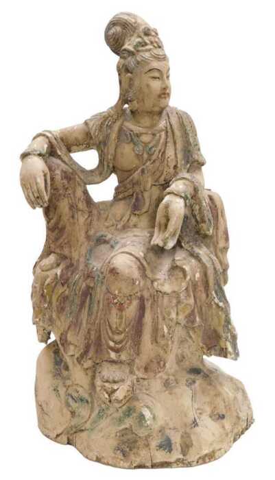 A Qing Dynasty 19thC Chinese wooden figure of Guanyin, modelled seated upon a rocky base,...