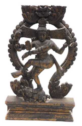 A 20thC Nataraja carved wooden sculpture of Lord Shiva, balanced on a dwarf Apasmara holding a...