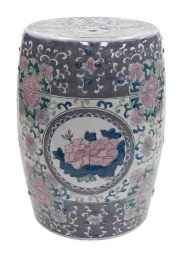 A late 20thC Chinese porcelain garden seat, of barrel form, decorated with reserves of flowers...