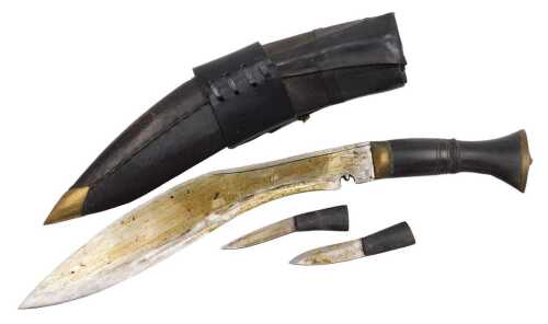 A 20thC Gurkha kukri knife, with a brass capped handle, and two additional knives, in a leather...