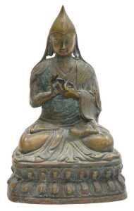 A 19thC Tibetan bronze figure of a Lama Tsongkapa, modelled seated in a lotus flower position,...