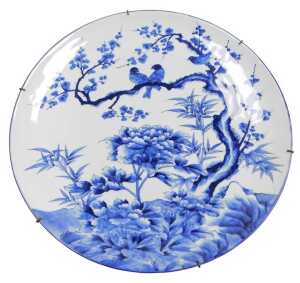 A Japanese Meiji period blue and white porcelain charger, decorated with birds, prunus blossom...