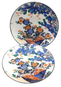 A pair of Japanese Meiji period Imari chargers, decorated with chrysanthemums and pine trees,...