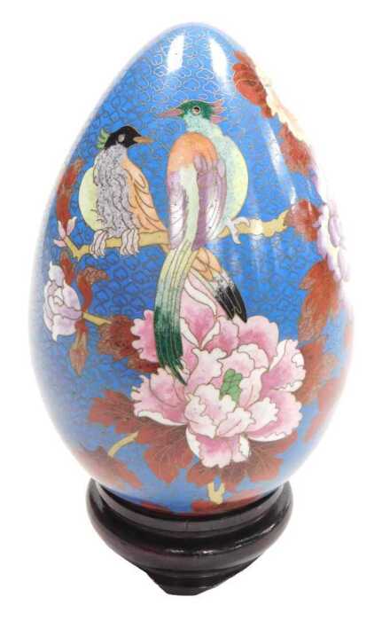 A late 20thC Chinese cloisonne enamel egg, on stand, decorated with birds on a bough with...