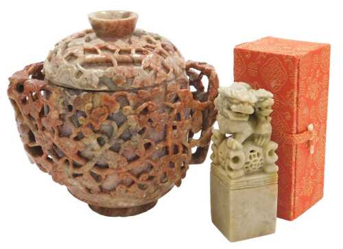 A 20thC Chinese soapstone pot and cover, of twin handled form, carved in relief with vines, 17cm...