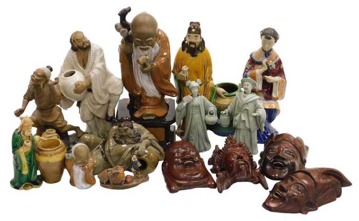 A group of 20thC Chinese Shiwan pottery mudman figures, including a seated lady, and deities,...
