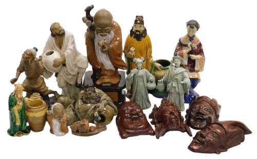 A group of 20thC Chinese Shiwan pottery mudman figures, including a seated lady, and deities,...