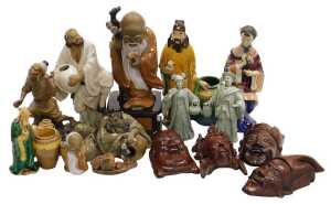 A group of 20thC Chinese Shiwan pottery mudman figures, including a seated lady, and deities,...