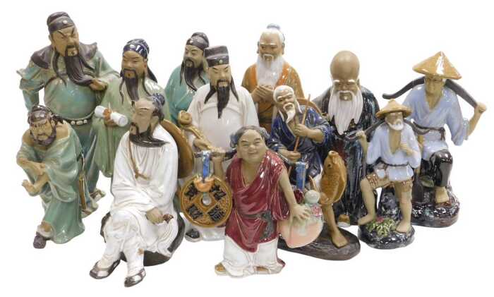 A group of 20thC Chinese Shiwan mudman figures, including deities, fishermen, and a woman...
