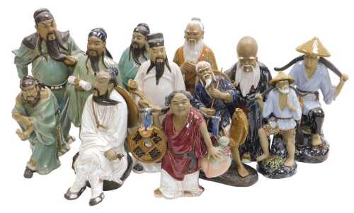 A group of 20thC Chinese Shiwan mudman figures, including deities, fishermen, and a woman...