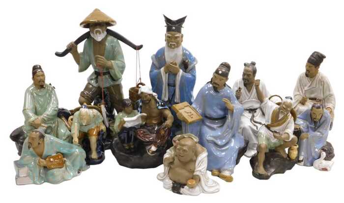 A group of 20thC Chinese Shiwan mudman figures, including a seated scholar, fisherman, a court...