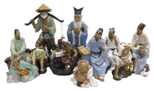 A group of 20thC Chinese Shiwan mudman figures, including a seated scholar, fisherman, a court...
