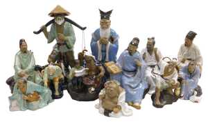 A group of 20thC Chinese Shiwan mudman figures, including a seated scholar, fisherman, a court...