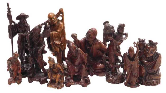 A group of 19thC and later Chinese hardwood carved figures, including deities, fishermen, a...