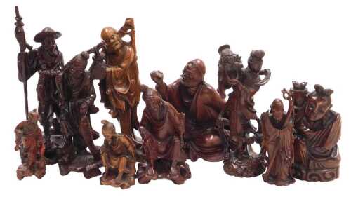 A group of 19thC and later Chinese hardwood carved figures, including deities, fishermen, a...