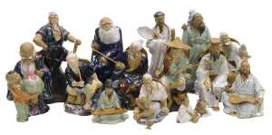 A group of 20thC Chinese Shiwan mudman figures, including fishermen, a deity with a child,...